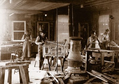 1890 black and white photo of young Native men in a woodworking shop