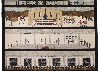 artwork pieced quilt with the words "The beginning of the end" at the top. 3 panels show Native people signing treaties, scenes of boarding school and the names of 6 students known to the artist who attended Toadlena Boarding School